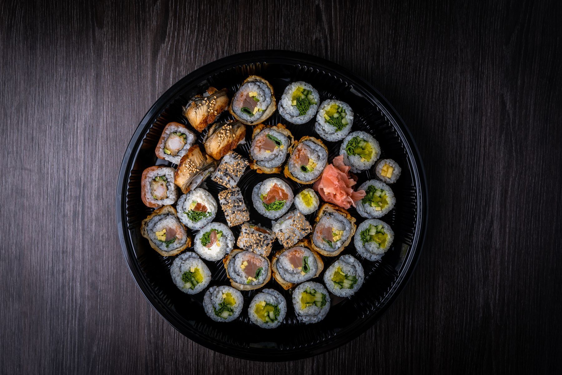 Bandeja redonda de maki sobre madera oscura